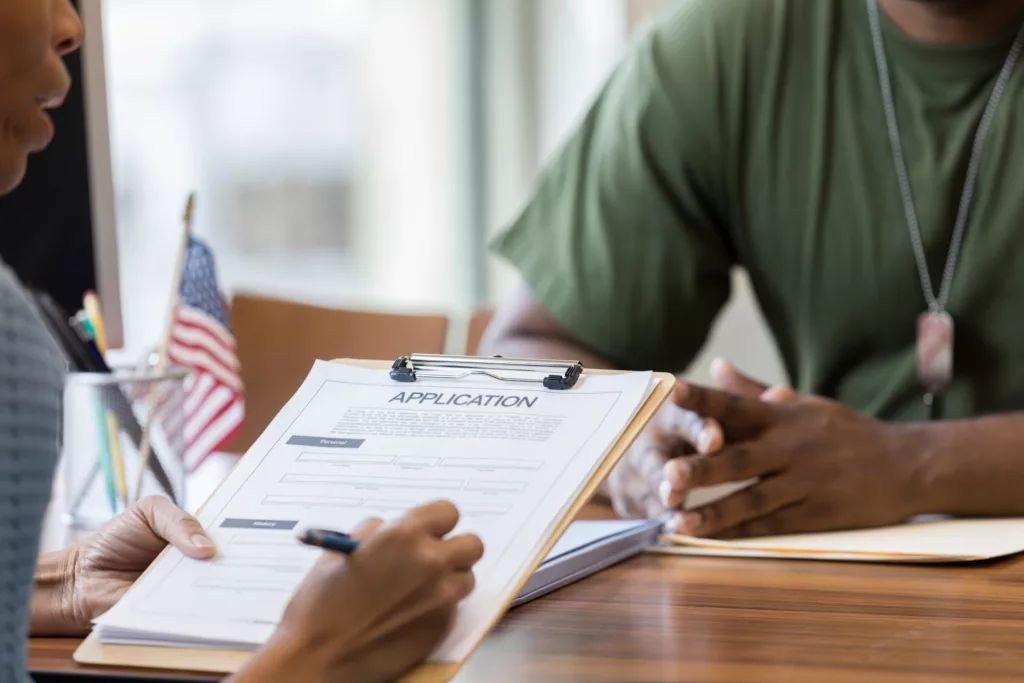 US veteran at a desk with a job recruiter learning about the best careers for veterans